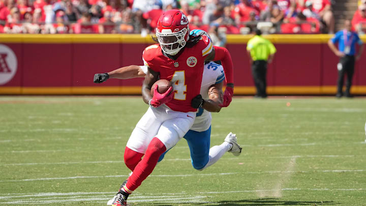 Aug 17, 2024; Kansas City, Missouri, USA; Kansas City Chiefs wide receiver Rashee Rice (4) runs the ball as Detroit Lions cornerback Khalil Dorsey (30) chases during the first half at GEHA Field at Arrowhead Stadium. Mandatory Credit: Denny Medley-Imagn Images