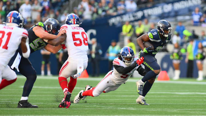 Oct 6, 2024; Seattle, Washington, USA; New York Giants linebacker Kayvon Thibodeaux (5) tackles Seattle Seahawks running back Kenneth Walker III (9) during the second half at Lumen Field. Mandatory Credit: Steven Bisig-Imagn Images Oct 6, 2024; Seattle, Washington, USA; New York Giants linebacker Kayvon Thibodeaux (5) tackles Seattle Seahawks running back Kenneth Walker III (9) during the second half at Lumen Field. Mandatory Credit: Steven Bisig-Imagn Images