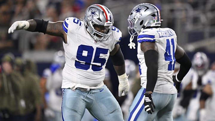Dallas Cowboys DT Kenny Clark celebrates with DE Donovan Ezeiruaku  after a sack against Arizona.