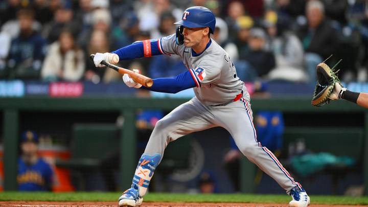 Apr 17, 2026; Seattle, Washington, USA; Texas Rangers center fielder Evan Carter (32) hits a bunt single against the Seattle Mariners during the third inning at T-Mobile Park. Mandatory Credit: Steven Bisig-Imagn Images Apr 17, 2026; Seattle, Washington, USA; Texas Rangers center fielder Evan Carter (32) hits a bunt single against the Seattle Mariners during the third inning at T-Mobile Park. Mandatory Credit: Steven Bisig-Imagn Images
