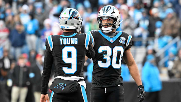 Dec 22, 2024; Charlotte, North Carolina, USA;  Carolina Panthers quarterback Bryce Young (9) and running back Chuba Hubbard (30) react in overtime at Bank of America Stadium. Mandatory Credit: Bob Donnan-Imagn Images