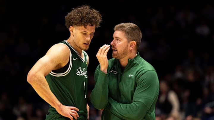 Le Moyne Dolphins head coach Nate Champion speaks to Le Moyne Dolphins guard/forward Tennessee Rainwater (1).