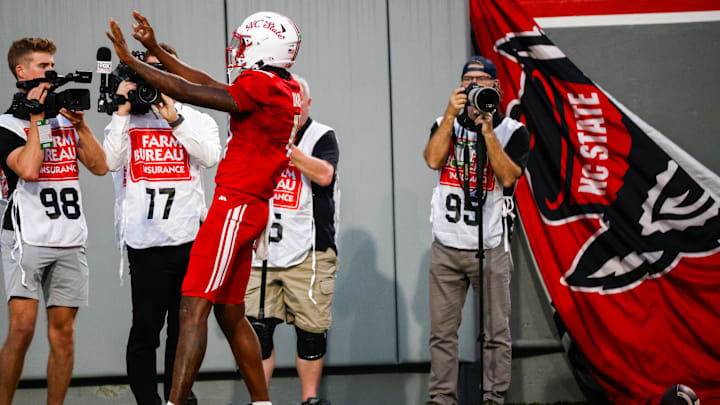 Aug 28, 2025; Raleigh, North Carolina, USA; North Carolina State Wolfpack quarterback CJ Bailey (11) celebrates a touchdown during the first half of the game against East Carolina Pirates at Carter-Finley Stadium. Mandatory Credit: Jaylynn Nash-Imagn Images