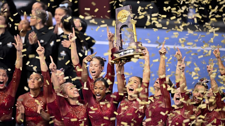 Oklahoma celebrates their seventh national championship with the trophy at the NCAA Gymnastics Championship at Dickies Arena in Fort Worth. 