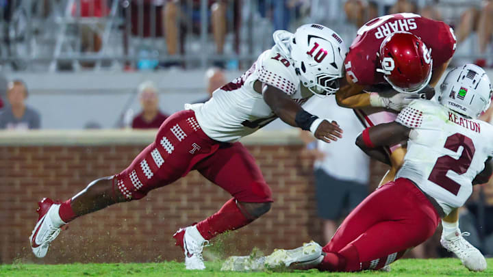 Aug 30, 2024; Norman, Oklahoma, USA;  Temple Owls linebacker Tyquan King (10) and Temple Owls safety Andreas Keaton (2) tackle Oklahoma Sooners tight end Bauer Sharp (10) during the second half at Gaylord Family-Oklahoma Memorial Stadium. Mandatory Credit: Kevin Jairaj-Imagn Images