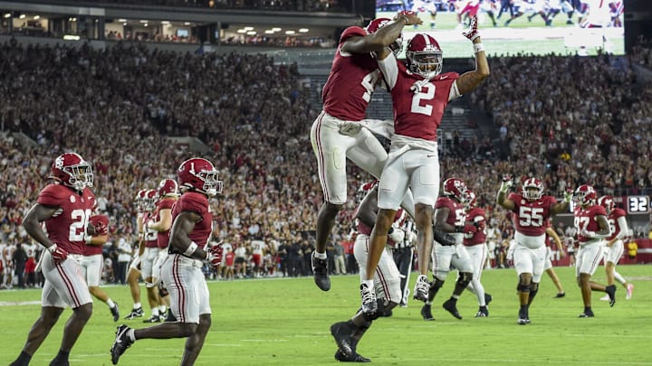 Aug 31, 2024; Tuscaloosa, Alabama, USA;  Alabama Crimson Tide quarterback Jalen Milroe (4) and wide receiver Ryan Williams (2) celebrate a touchdown by Williams against the Western Kentucky Hilltoppers at Bryant-Denny Stadium. Mandatory Credit: Gary Cosby Jr.-USA TODAY Sports