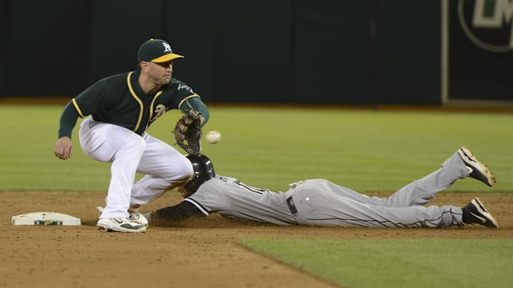 May 12, 2014; Oakland, CA, USA; Chicago White Sox shortstop Alexei Ramirez (10, right) steals second base against Oakland Athletics second baseman Nick Punto (1, left) during the ninth inning at O.co Coliseum. The Athletics defeated the White Sox 5-4. Mandatory Credit: Kyle Terada-Imagn Images