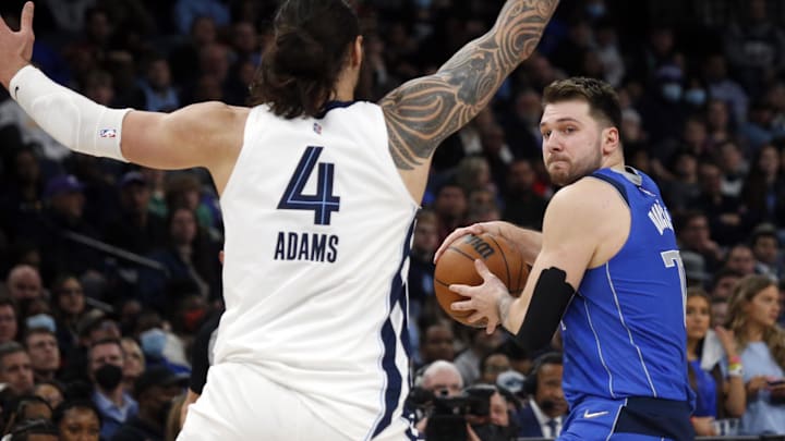 Jan 14, 2022; Memphis, Tennessee, USA; Dallas Mavericks guard Luka Doncic (77) passes the ball as Memphis Grizzles center Steven Adams (4) defends during the second half at FedExForum. Mandatory Credit: Petre Thomas-Imagn Images