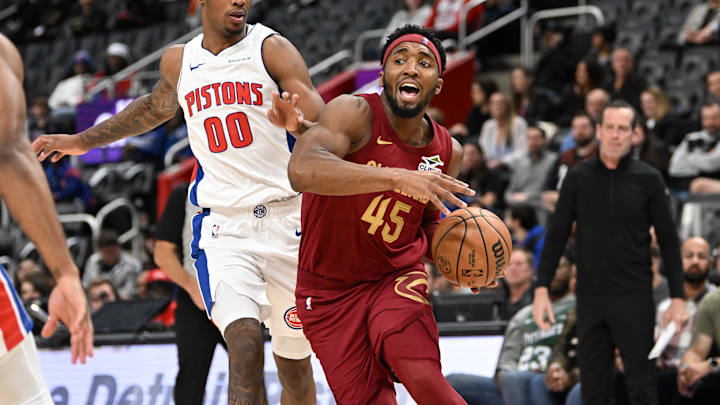 Oct 16, 2024; Detroit, Michigan, USA; Cleveland Cavaliers guard Donovan Mitchell (45) drives to the basket past Detroit Pistons forward Ron Holland II (00) in the second quarter at Little Caesars Arena. Mandatory Credit: Lon Horwedel-Imagn Images
