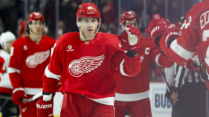 Mar 27, 2025; Detroit, Michigan, USA;  Detroit Red Wings right wing Patrick Kane (88) is congratulated by teammates after scoring in the third period against the Ottawa Senators at Little Caesars Arena. Mandatory Credit: Rick Osentoski-Imagn Images