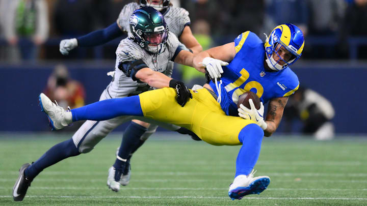 Dec 18, 2025; Seattle, Washington, USA; Seattle Seahawks safety Ty Okada (39) tackles Los Angeles Rams tight end Terrance Ferguson (18) in the second half at Lumen Field. Mandatory Credit: Steven Bisig-Imagn Images
