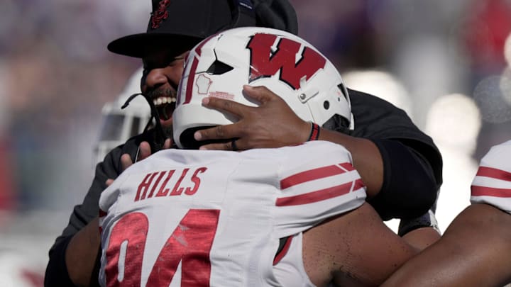 Wisconsin defensive lineman Elijah Hills (94) is hugged by defensive line coach E.J. Whitlow after recovering a Northwestern fumble during the second quarter of their game Saturday October 19, 2024 at Lanny and Sharon Martin Stadium in Evanston, Illinois. Wisconsin defensive lineman Elijah Hills (94) is hugged by defensive line coach E.J. Whitlow after recovering a Northwestern fumble during the second quarter of their game Saturday October 19, 2024 at Lanny and Sharon Martin Stadium in Evanston, Illinois.