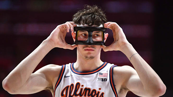 Jan 8, 2026; Champaign, Illinois, USA;  Illinois Fighting Illini forward Zvonimir Ivisic (44) adjusts his protective mask during the first half against the Rutgers Scarlet Knights at State Farm Center. Mandatory Credit: Ron Johnson-Imagn Images