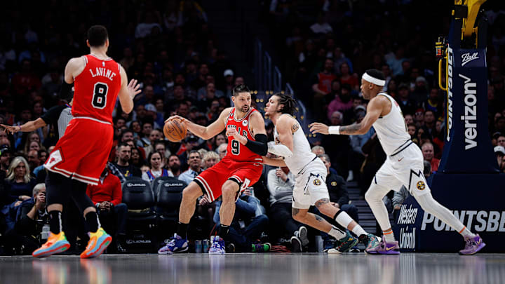 Mar 8, 2023; Denver, Colorado, USA; Chicago Bulls center Nikola Vucevic (9) controls the ball against Denver Nuggets forward Aaron Gordon (50) as guard Zach LaVine (8) and forward Bruce Brown (11) defend in the fourth quarter at Ball Arena. Mandatory Credit: Isaiah J. Downing-Imagn Images