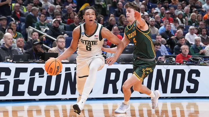 Mar 19, 2026; Buffalo, NY, USA; Michigan State Spartans forward Jordan Scott (6) drives to the basket against North Dakota State Bison guard Andy Stefonowicz (5) during the first half during a first round game of the men's 2026 NCAA Tournament at Keybank Center. Mandatory Credit: Gregory Fisher-Imagn Images
