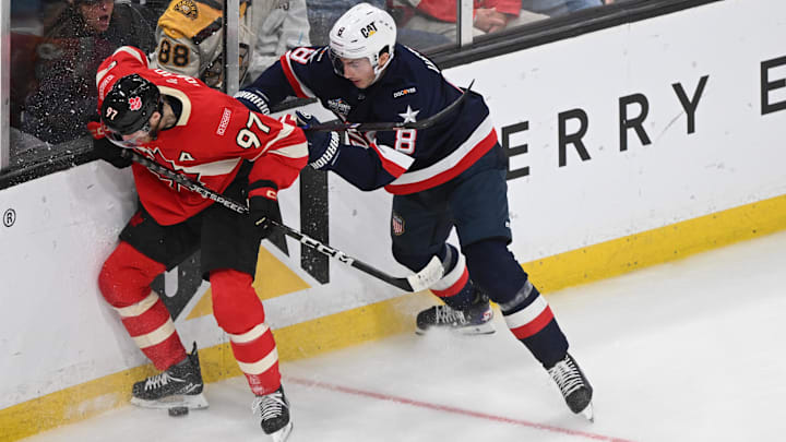 Feb 20, 2025; Boston, MA, USA; [Imagn Images direct customers only]  Team Canada forward Connor McDavid (97) battles for the puck against Team USA defenseman Zach Werenski (8) during the 4 Nations Face-Off ice hockey championship game at TD Garden. Mandatory Credit: Brian Fluharty-Imagn Images