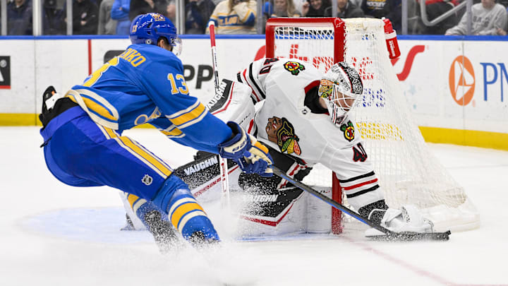 Mar 22, 2025; St. Louis, Missouri, USA;  Chicago Blackhawks goaltender Arvid Soderblom (40) looses the puck to St. Louis Blues right wing Alexey Toropchenko (13) during the second period  at Enterprise Center. Mandatory Credit: Jeff Curry-Imagn Images