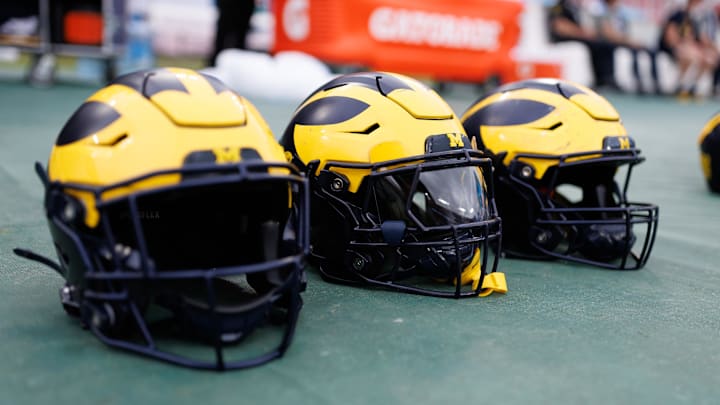 Dec 31, 2024; Tampa, FL, USA; Michigan Wolverines helmets sit on the field before a game against the Alabama Crimson Tide at Raymond James Stadium. Mandatory Credit: Matt Pendleton-Imagn Images