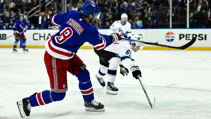 Oct 12, 2024; New York, New York, USA; New York Rangers defenseman Jacob Trouba (8) shoots the puck as Utah Hockey Club left wing Matias Maccelli (63) defends during the second period at Madison Square Garden. Mandatory Credit: John Jones-Imagn Images