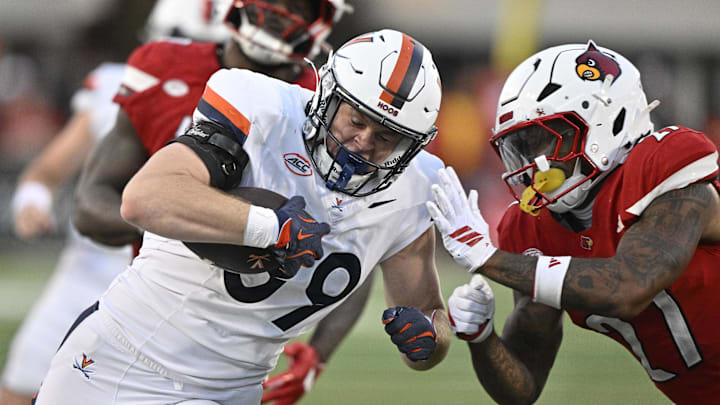 Oct 4, 2025; Louisville, Kentucky, USA; Virginia Cavaliers tight end John Rogers (89) runs the ball against Louisville Cardinals defensive back JoJo Evans Jr. (27) during the second half at L&N Federal Credit Union Stadium. Virginia defeated Louisville 30-27. Mandatory Credit: Jamie Rhodes-Imagn Images Oct 4, 2025; Louisville, Kentucky, USA; Virginia Cavaliers tight end John Rogers (89) runs the ball against Louisville Cardinals defensive back JoJo Evans Jr. (27) during the second half at L&N Federal Credit Union Stadium. Virginia defeated Louisville 30-27. Mandatory Credit: Jamie Rhodes-Imagn Images