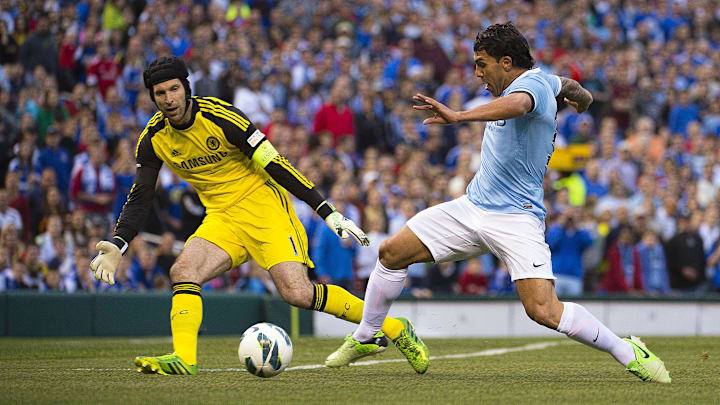 May 23, 2013; St. Louis, MO, USA; Manchester City forward Carlos Tevez (32) takes a shot as Chelsea goalkeeper Petr Cech (1) watches the ball at Busch Stadium. Manchester City defeated Chelsea 4-3. Mandatory Credit: Scott Rovak-Imagn Images