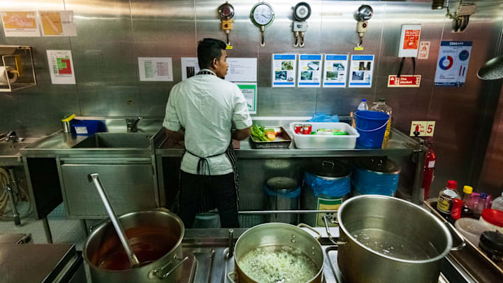 A chef cooks in the galley of a ship, Oman sea, Indian Ocean British Territorry