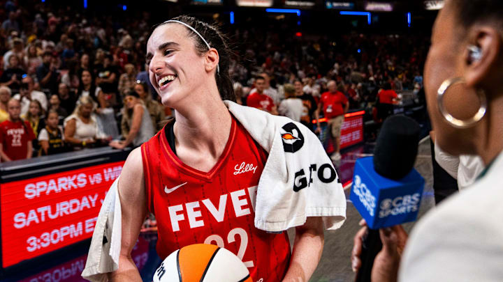 Jul 6, 2024; Indianapolis, Indiana, USA; Indiana Fever guard Caitlin Clark (22) smiles in an interview after becoming the first rookie to have a triple-double during a game against the New York Liberty at Gainbridge Fieldhouse. Mandatory Credit: Grace Smith/INDIANAPOLIS STAR-Imagn Images