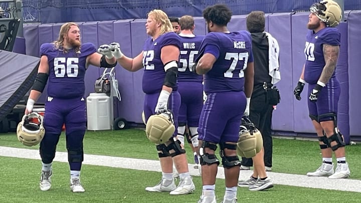 Landen Hatchett (66) and John Mills (72) share a fist bump.