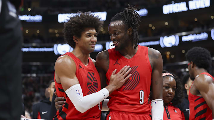 Dec 2, 2023; Salt Lake City, Utah, USA; Portland Trail Blazers guard Matisse Thybulle (4) helps forward Jerami Grant (9) off of the floor after hitting his head against the Utah Jazz during the second half at Delta Center. Mandatory Credit: Rob Gray-Imagn Images