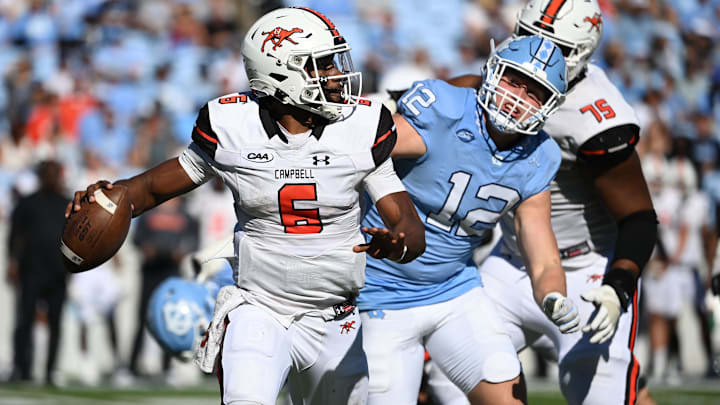 Nov 4, 2023; Chapel Hill, North Carolina, USA; Campbell Fighting Camels quarterback Hajj-Malik Williams (6) looks to pass as North Carolina Tar Heels defensive lineman Beau Atkinson (12) pressures in the third quarter at Kenan Memorial Stadium. Mandatory Credit: Bob Donnan-Imagn Images Nov 4, 2023; Chapel Hill, North Carolina, USA; Campbell Fighting Camels quarterback Hajj-Malik Williams (6) looks to pass as North Carolina Tar Heels defensive lineman Beau Atkinson (12) pressures in the third quarter at Kenan Memorial Stadium. Mandatory Credit: Bob Donnan-Imagn Images