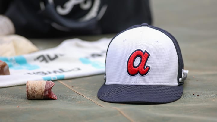 Apr 10, 2024; Atlanta, Georgia, USA; A detailed view of an Atlanta Braves hat on the field during batting practice at Truist Park. The game against the New York Mets was postponed due to impending weather. Mandatory Credit: Brett Davis-Imagn Images Apr 10, 2024; Atlanta, Georgia, USA; A detailed view of an Atlanta Braves hat on the field during batting practice at Truist Park. The game against the New York Mets was postponed due to impending weather. Mandatory Credit: Brett Davis-Imagn Images