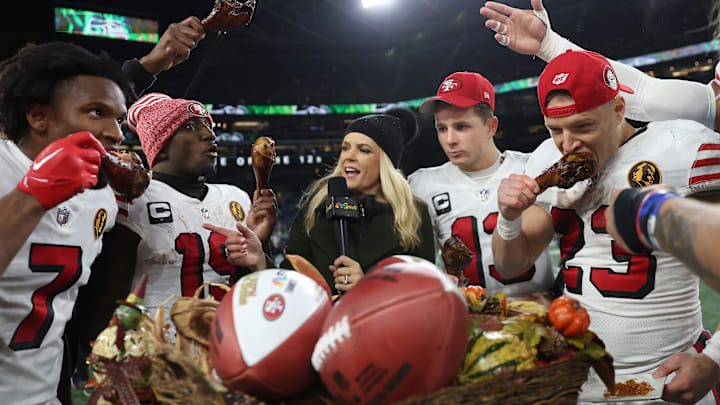 San Francisco 49ers players eat turkey at midfield after the win over the Seahawks on Thanksgiving.