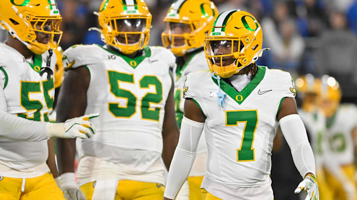 Ex-UW cornerback Jabbar Muhammad (7) leaves the field with Oregon defensive linemen Derrick Harmon (55) and A'Mauri Washington (52) agains UCLA. 