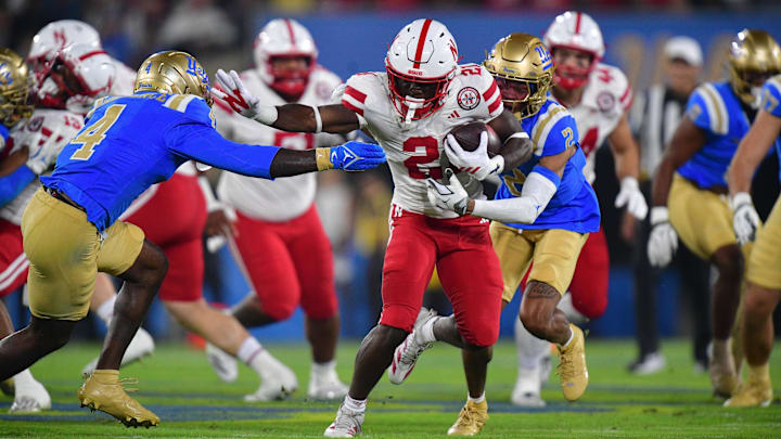 Nov 8, 2025; Pasadena, California, USA; Nebraska Cornhuskers running back Emmett Johnson (21) runs the ball against the UCLA Bruins during the first half at the Rose Bowl.