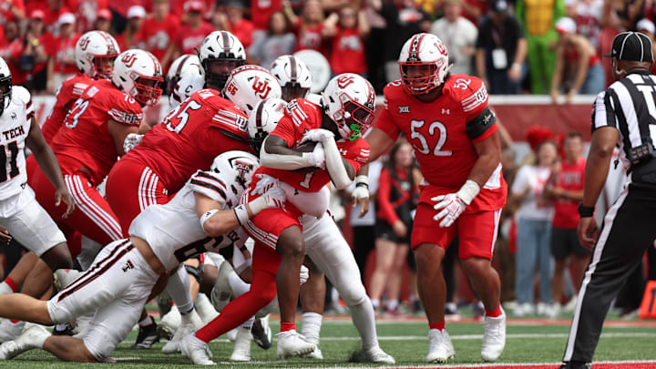 Utah Utes running back Wayshawn Parker (1) runs for a touchdown as Texas Tech Red Raiders linebacker John Curry (6) defends during the fourth quarter at Rice-Eccles Stadium. Utah Utes running back Wayshawn Parker (1) runs for a touchdown as Texas Tech Red Raiders linebacker John Curry (6) defends during the fourth quarter at Rice-Eccles Stadium.