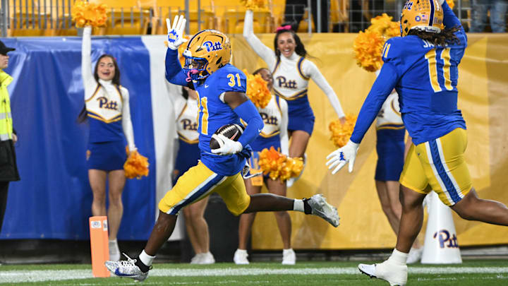 Oct 24, 2024; Pittsburgh, Pennsylvania, USA; Pittsburgh Panthers linebacker Rasheem Biles (31) returns an interception for a touchdown against the Syracuse Orange during the first quarter at Acrisure Stadium. Mandatory Credit: Barry Reeger-Imagn Images Oct 24, 2024; Pittsburgh, Pennsylvania, USA; Pittsburgh Panthers linebacker Rasheem Biles (31) returns an interception for a touchdown against the Syracuse Orange during the first quarter at Acrisure Stadium. Mandatory Credit: Barry Reeger-Imagn Images