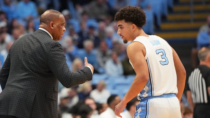 Jan 21, 2026; Chapel Hill, North Carolina, USA; North Carolina Tar Heels head coach Hubert Davis with guard Derek Dixon (3) in the first half at Dean E. Smith Center. Mandatory Credit: Bob Donnan-Imagn Images
