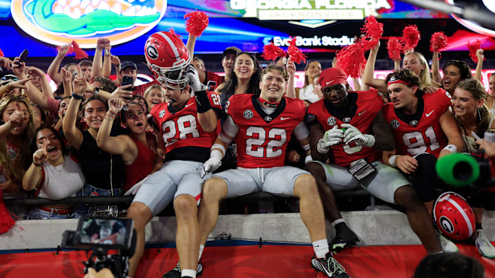 Georgia Bulldogs wide receiver Walter Blanchard (28), defensive back Jake Pope (22), Georgia Bulldogs running back Nate Frazier (3) and place kicker Peyton Woodring (91) celebrate after the game of an NCAA college football matchup Saturday, Nov. 2, 2024 at EverBank Stadium in Jacksonville, Fla. The Georgia Bulldogs defeated the Florida Gators 34-20. [Corey Perrine/Florida Times-Union]