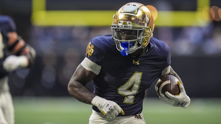 Oct 19, 2024; Atlanta, Georgia, USA; Notre Dame Fighting Irish running back Jeremiyah Love (4) runs against the Georgia Tech Yellow Jackets during the second half at Mercedes-Benz Stadium. Mandatory Credit: Dale Zanine-Imagn Images