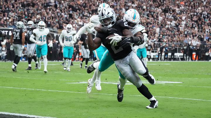Las Vegas Raiders running back Ashton Jeanty (2) scores on a 13-yard touchdown pass against Miami Dolphins linebacker Jordyn Brooks (20) in the first half at Allegiant Stadium. Las Vegas Raiders running back Ashton Jeanty (2) scores on a 13-yard touchdown pass against Miami Dolphins linebacker Jordyn Brooks (20) in the first half at Allegiant Stadium.