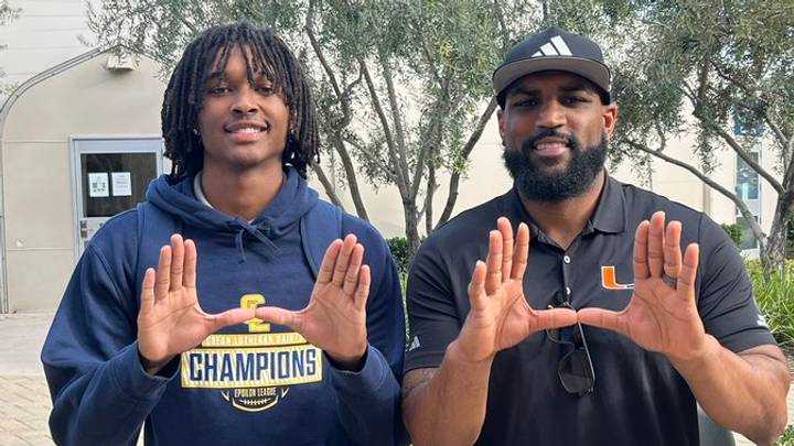 Evan Mack and former UW assistant Will Harris, now with Miami, share a recruiting moment. Evan Mack and former UW assistant Will Harris, now with Miami, share a recruiting moment.
