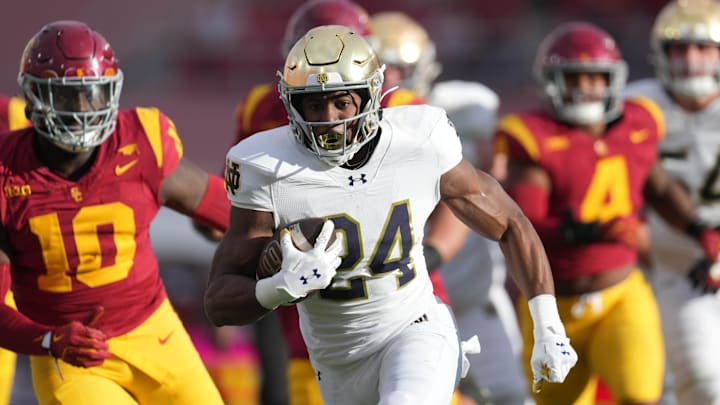 Nov 30, 2024; Los Angeles, California, USA; Notre Dame Fighting Irish running back Jadarian Price (24) scores on a 36-yard touchdown run against the Southern California Trojans in the second half at United Airlines Field at Los Angeles Memorial Coliseum. Nov 30, 2024; Los Angeles, California, USA; Notre Dame Fighting Irish running back Jadarian Price (24) scores on a 36-yard touchdown run against the Southern California Trojans in the second half at United Airlines Field at Los Angeles Memorial Coliseum.