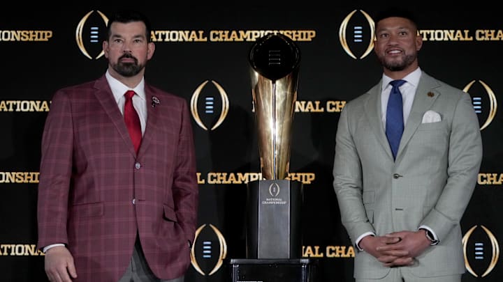 Jan 19, 2025; Atlanta, GA, USA; Ohio State Buckeyes head coach Ryan Day (left) and Notre Dame Fighting Irish head coach Marcus Freeman pose with the College Football Playoff National Championship trophy at press conference at The Westin Peachtree Plaza, Savannah Ballroom. 