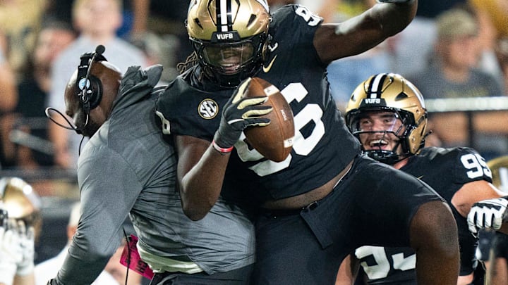 Vanderbilt defensive line coach Larry Black and Vanderbilt defensive lineman Khordae Sydnor (96) celebrate Sydnor's second-half fumble recovery during their game at FirstBank Stadium in Nashville, Tenn., Saturday, Aug. 30, 2025.