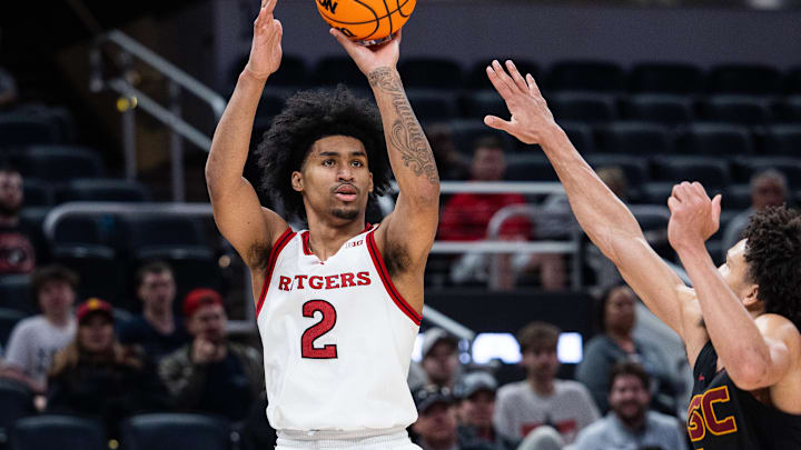 Mar 12, 2025; Indianapolis, IN, USA; Rutgers Scarlet Knights guard Dylan Harper (2) shoots the ball while USC Trojans guard Desmond Claude (1) defends in the second half at Gainbridge Fieldhouse. Mandatory Credit: Trevor Ruszkowski-Imagn Images