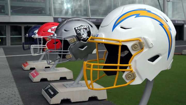Oct 13, 2024; London, United Kingdom; Large helmets of the Los Angeles Chargers, Las Vegas Raiders, Kansas City Chiefs and Denver Broncos of the AFC West before an NFL International Series game at Tottenham Hotspur Stadium. Mandatory Credit: Kirby Lee-Imagn Images