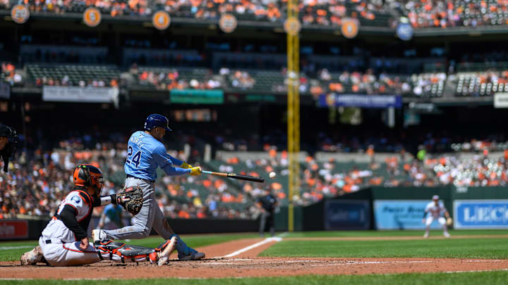 Sep 8, 2024; Baltimore, Maryland, USA; Tampa Bay Rays second baseman Christopher Morel (24) hits a single during the first inning against the Baltimore Orioles at Oriole Park at Camden Yards.