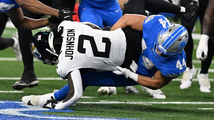Nov 17, 2024; Detroit, Michigan, USA; Jacksonville Jaguars running back D'Ernest Johnson (2) gets tackled by Detroit Lions linebacker Malcolm Rodriguez (44) in the first quarter at Ford Field. Mandatory Credit: Lon Horwedel-Imagn Images