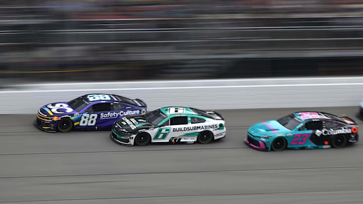 Jun 8, 2025; Brooklyn, Michigan, USA; NASCAR Cup Series drivers Shane van Gisbergen (88) Brad Keselowski (6), and Bubba Wallace (23) race down the main straightaway during stage three of the FireKeepers Casino 400 at Michigan International Speedway.