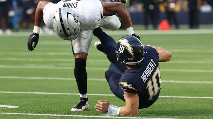 Justin Herbert broke a bone in his left hand against the Raiders